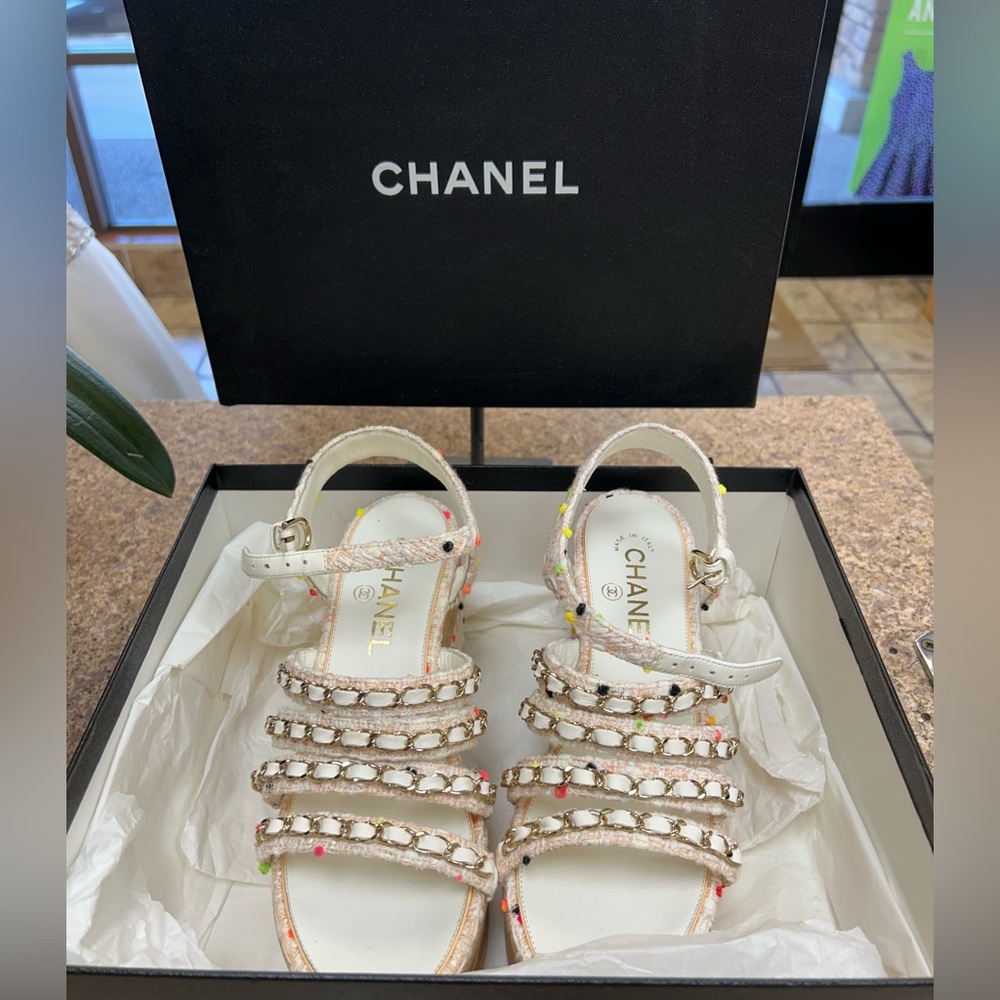 Chanel White Sandals with classic chain attachment.